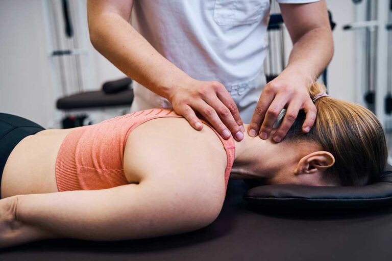 A person receiving soft tissue treatment with metal instruments on the calf muscle in a clinical setting.